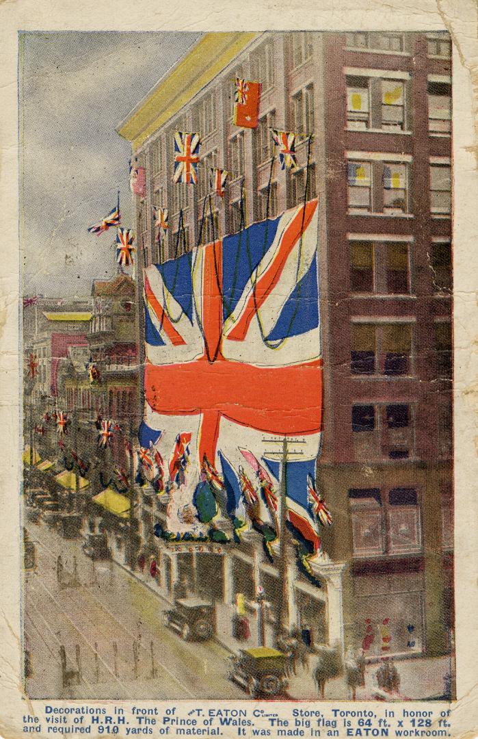 Colorized photograph of the exterior of a department store with a gigantic union jack hanging i…