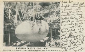 Black and white photograph of a huge Easter Egg in the rotunda of a very large retail shop.