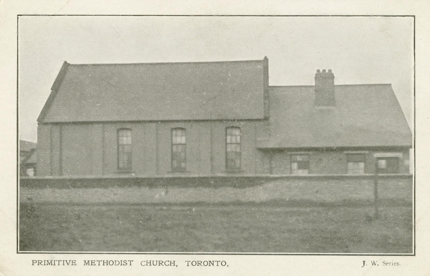 Black and white photograph of one story, frame church building.