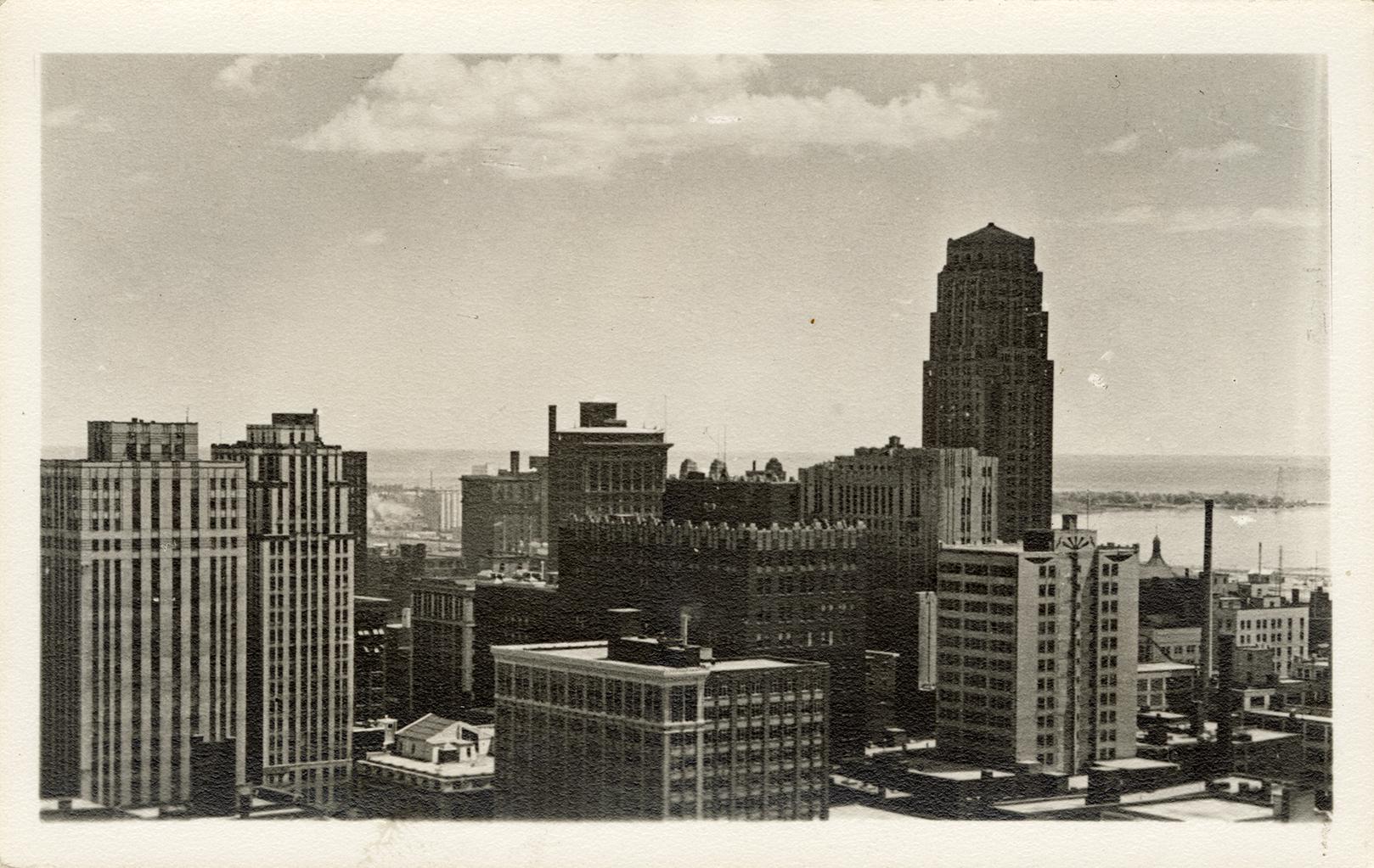  Black and white, aerial shot of tall skyscrapers.