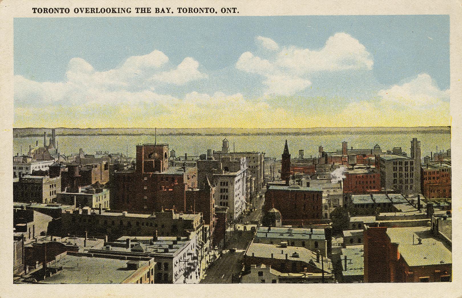 Colorized photograph of a busy street with large building on with side of it.