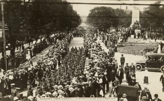 Black and white picture of soldiers marching down a wide street with the South African war memo…