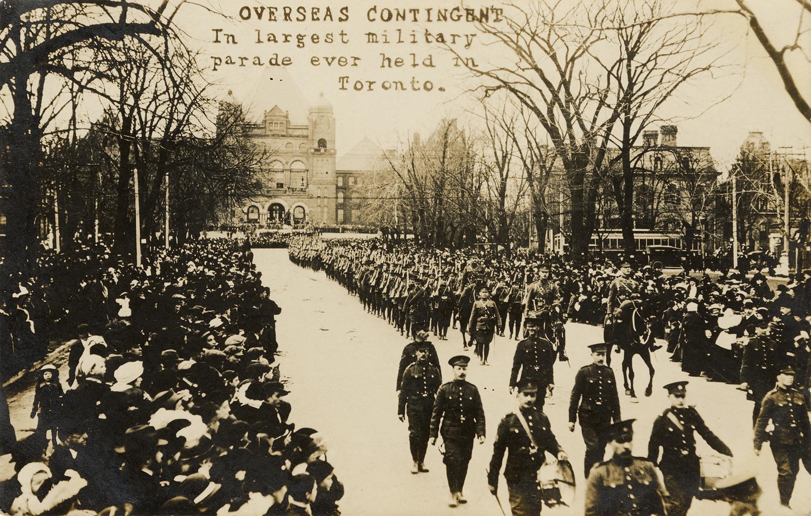 Black and white picture of soldiers marching on an icy city street while crowds of civilians lo…