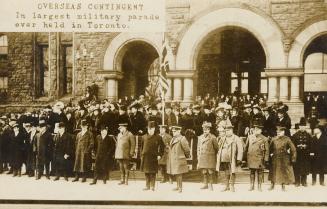 Black and white picture of dignitaries standing on the steps of large, Richardsonian Romanesque…