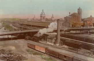 Colour photo postcard depicting an aerial view of trains and a bridge, slightly above and adjac…