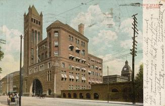 Colour postcard depicting a ground view of the exterior of Union station with two horse-drawn b…