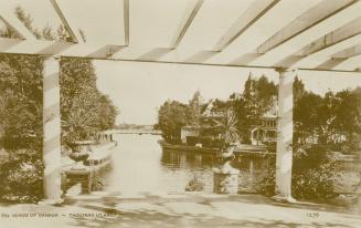 Sepia toned picture of a view of a waterway, taken from the terrace of a summer home.