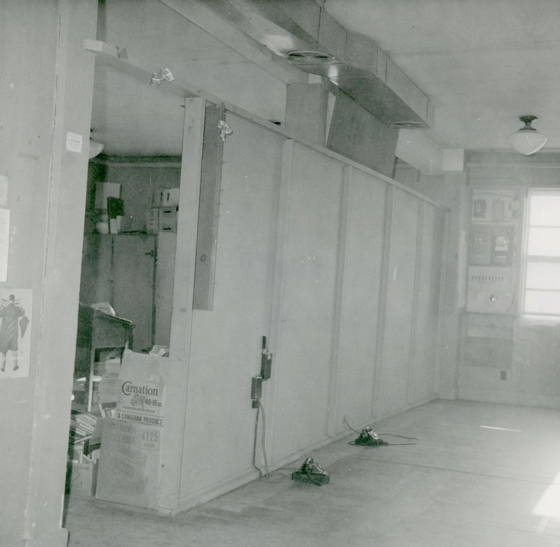 Picture of a empty room with telephones on the floor. 