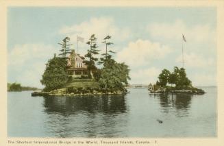 Colorized photograph of a view of a waterway, with a large summer resort on an island connected…