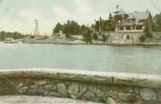 Colorized photograph of river with a large house on an island, taken from the terrace if anothe…