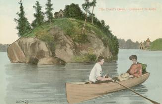 Colorized photograph of a man and a woman in a row boat in a body of water in front of an islan…