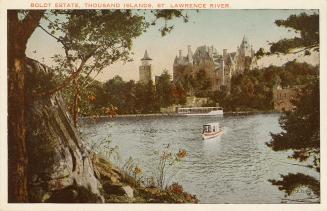 Color photograph of a large, stone castle in an island in the middle of a waterway.