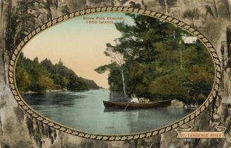 Colorized photograph of a man in a boat on a river banked by trees. Picture is in an oval frame…