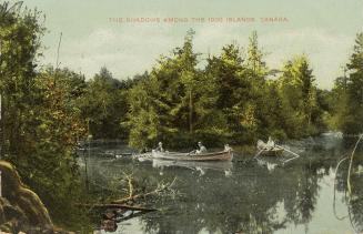 Colorized photograph of of people in two rowboats in front of densely forested islands in a riv…