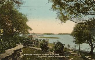 Colorized photograph of a large body of water with island in the background, taken from the ter…