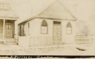 Sepia-toned postcard depicting the front of a residential building with the caption at the bott…