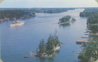 Color photograph of a large ship on a large river with islands in it.