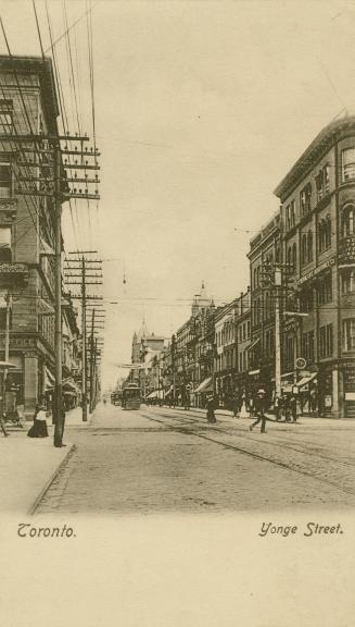 Sepia-toned photo postcard depicting a view of Yonge Street looking north from King Street with…