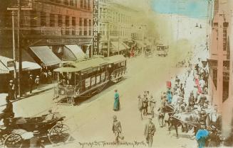 Colour photo postcard depicting a view of Yonge Street looking north from King Street with stre…