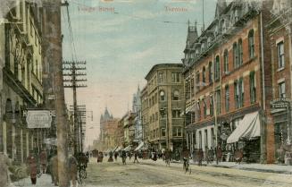 Colour photo postcard depicting a view of Yonge Street looking north from Melinda Street with h…