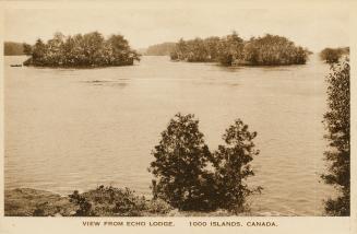 Sepia toned photograph of islands in the middle of a wide river. 