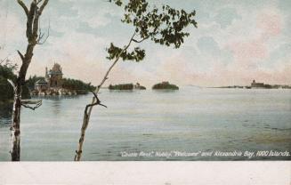 Islands in the middle of a large body of water, one with a castle on it.