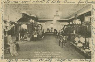 Black and white photo postcard depicting the interior of a fur store on Yonge Street. The capti…