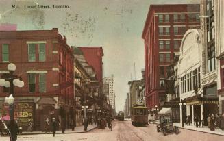 Colour postcard depicting a view of Yonge Street with a streetcar, car, horse-drawn wagons, a m…