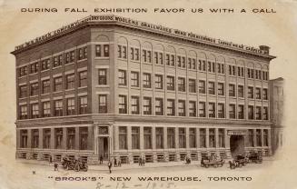 Black and white photograph of a large factory building taken from a corner.