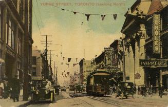 Colour postcard depicting a view of Yonge Street with a streetcar, cars, many shops, and pedest…