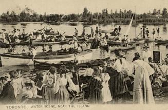 Black and white photograph of crowds of people in row and sail boats with even more people watc…