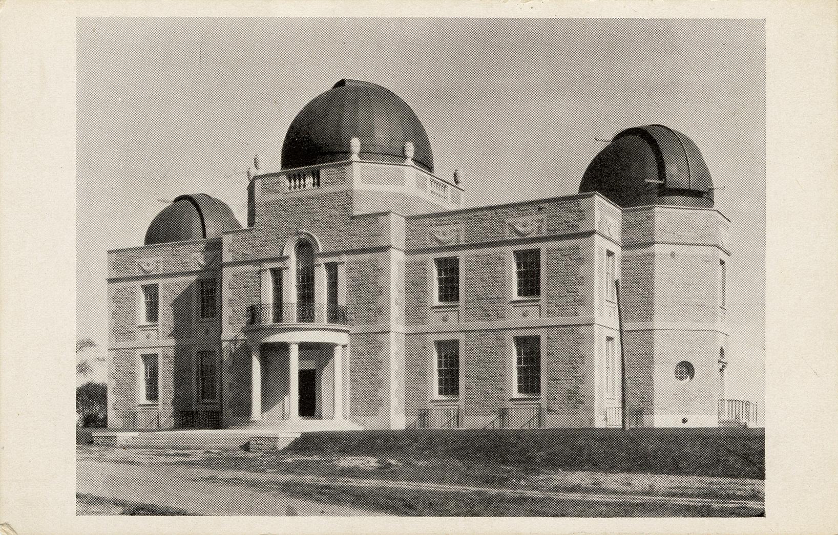 Black and white aerial photograph of a stone building with domes.