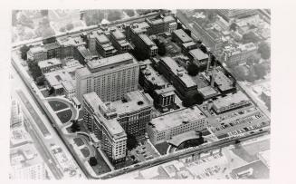 Black and white, aerial photograph of a huge hospital complex taking up many city blocks.