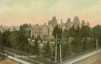 Colorized photograph of a large hospital complex surrounded by trees.