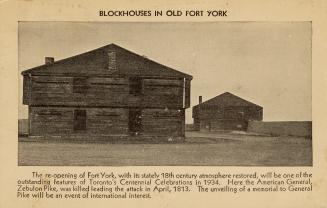 Black and white photograph of a two story, wooden structure.