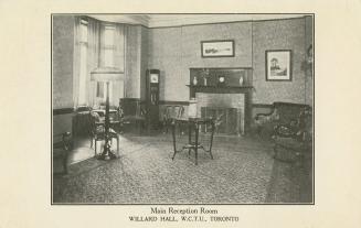 Black and white photograph of the interior of a formal living room with fireplace.