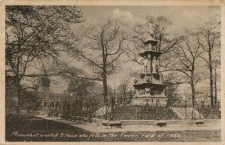 Sepia-toned photo postcard depicting a statue in a wooded / park area. The caption at the botto…