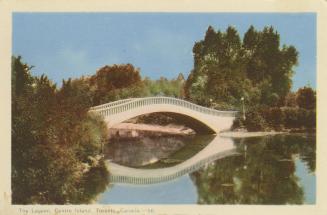 Colorized photograph of a curved bridge spanning a narrow body of water,