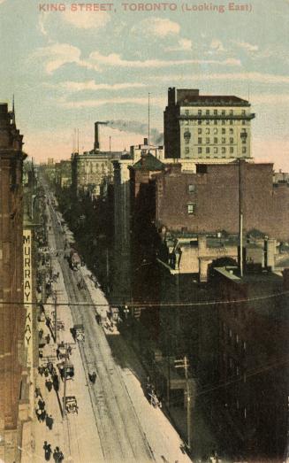 Colour photo postcard of King Street looking east towards Yonge Street, with a Murray Kay sign …