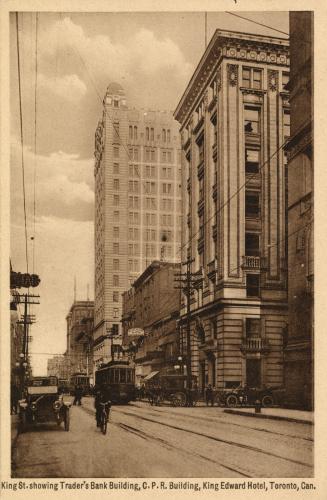 Sepia-toned photo postcard of a view of King Street West, looking east from Jordan Street, with…