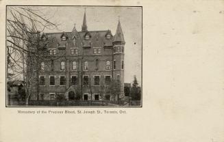 Black and postcard with inset photo depicting the exterior of a 5-story building. The caption a…