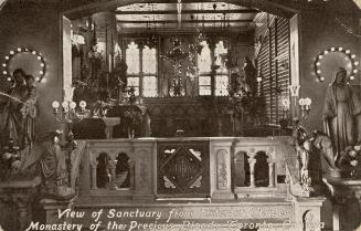 Black and photo postcard depicting a religious nook adorned with Catholic ornaments. The captio…