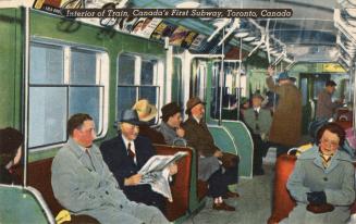 Colour photo postcard depicting the interior of a subway train with passengers sitting and stan…