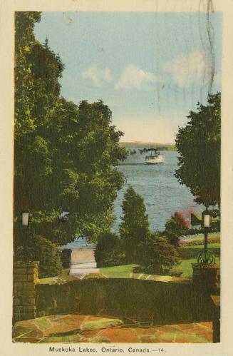 Colorized photograph of a large resort building on the edge of a smooth waterway.