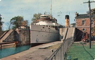 Color photograph of a large boat docked.