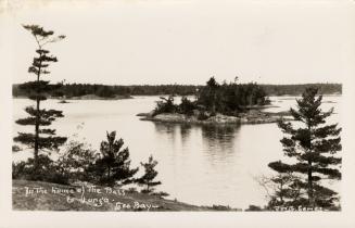 Black and white photograph of islands in a body of water.