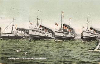 Color photograph of four large boats in open water.