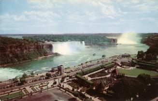 Color photograph of two waterfalls and a river of rapids taken from the air.