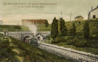 Colorized photograph of a steam training running under a stone opening to a tunnel.