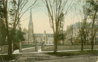 Colour photo postcard depicting a property encompassing a church and a four-story building. The…